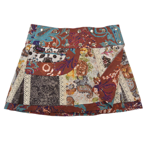 Sommerrock aus Baumwolle in buntem Mustermix und weißer Spitze. Umfang ist verstellbar mit doppelter Druckknopfleiste mit Seitentasche.