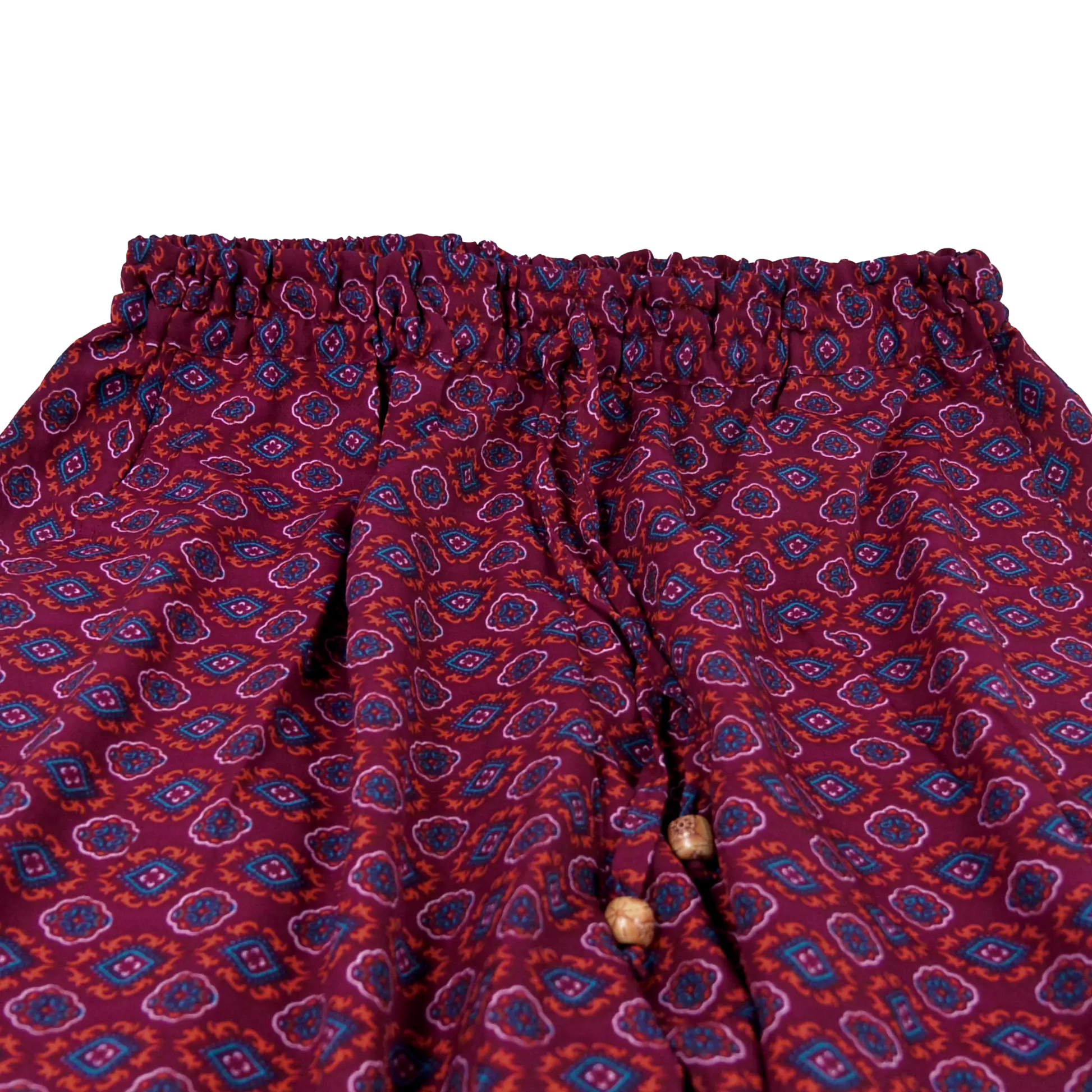 Hose aus Polyester, lila Muster mit elastischen Bund und Kordelzug am Saum . Zwei Holzperlen schmücken die Kordelenden.