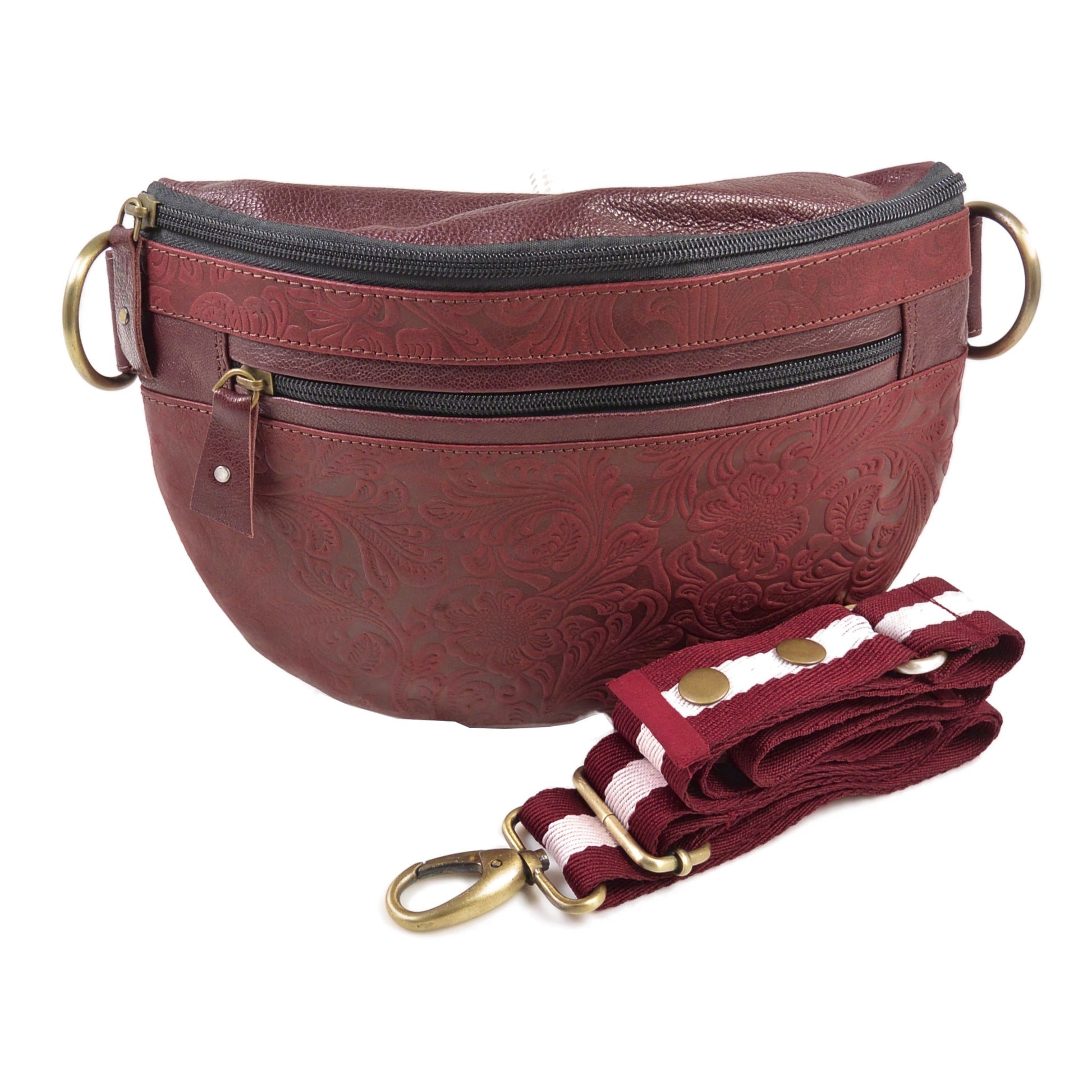 Crossbody-Bag sowie Bauchtasche aus Leder in Rot mit floraler Prägung. Das Hauptfach hat ein integriertes Fach mit Reißverschluss und ein Reißverschlussfach vorne.