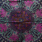 Detailaufnahme einer Mandala-Decke in Lila-Türkis mit floralen Elementen und Elefantenmotiven im Kreisdesign