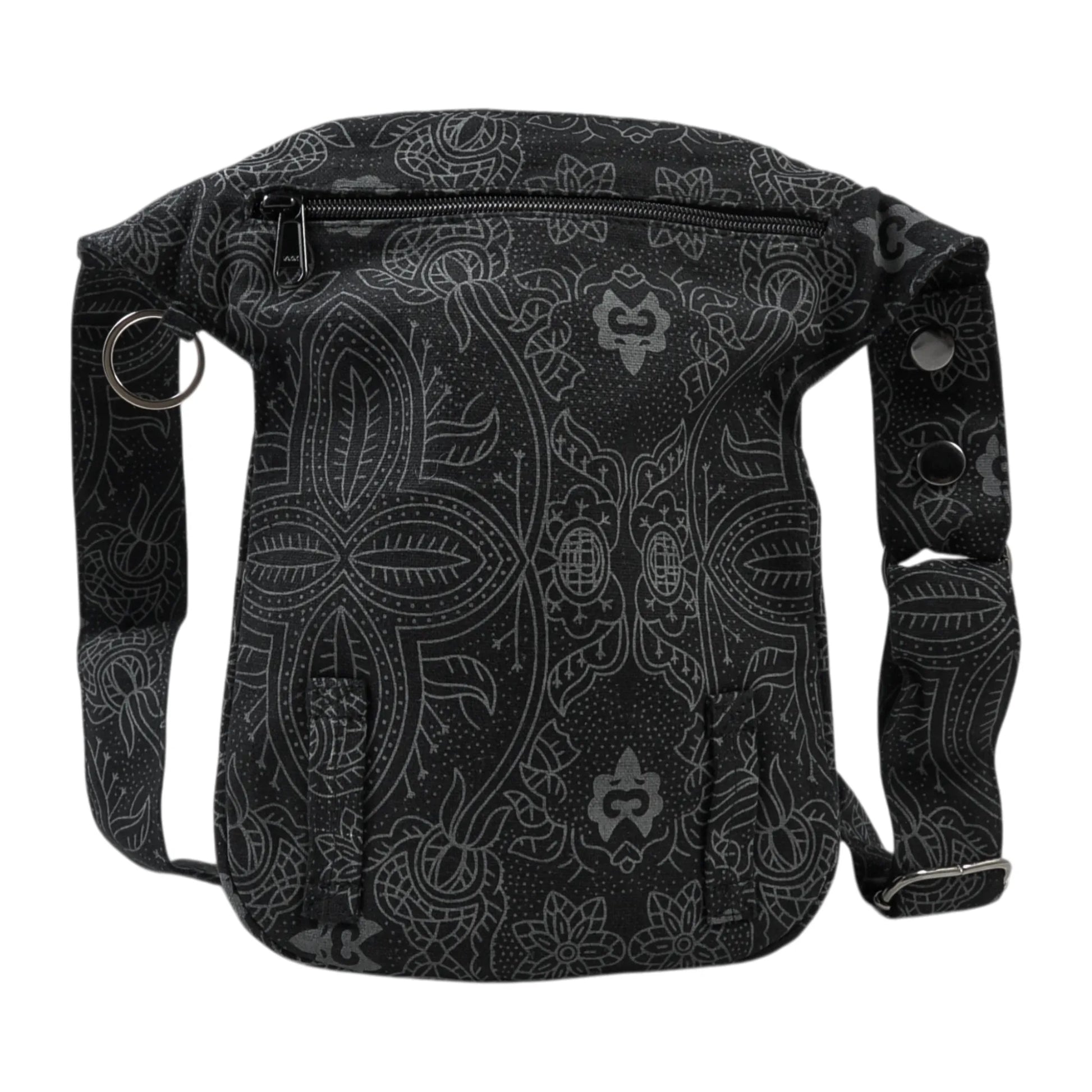 Nijens Gassitasche Hannover aus Canvas-Baumwolle in Schwarz mit floralem Muster, Rückansicht mit Druckknopfklappe, Reißverschlussfach und verstellbarem Gurt.