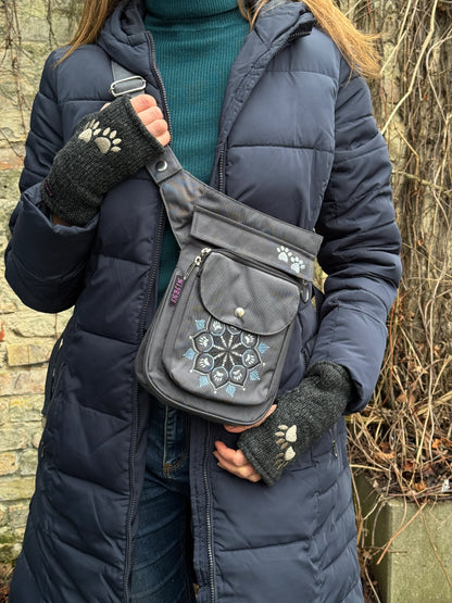 Model präsentiert Gürteltasche aus wasserabweisendem Nylonstoff in Dunkelgrau mit Pfoten-Mandalastickerei. 