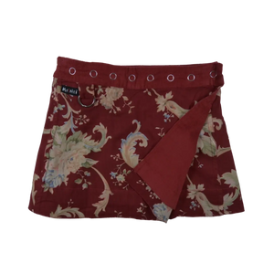 Wenderock für Kinder aus Baumwolle Bordeauxrot mit Blumenornamenten und Druckknopfleiste.