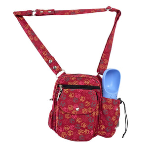 Rote Nijens-Gassitasche mit buntem Pfotenmuster und integrierter blauer Trinkflasche – ideal für Spaziergänge mit dem Hund.