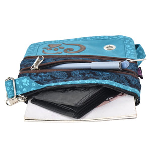 Gassi-UmhĂ€ngetasche aus Stoff TĂŒrkis, Schwarz mit Paisley und kleinen Pfoten Prints. Vorne verziert ein Herz, Pfoten AufnĂ€her die Tasche. Das Hauptfach lĂ€sst sich mit einem ReiĂverschluss verschlieĂen und bietet Platz fĂŒr Portemonnaie, Handy und weitere Kleinigkeiten. Der Innenstoff des oberste ReiĂverschlussfach vorne, ist wasserabweisend und waschbar.