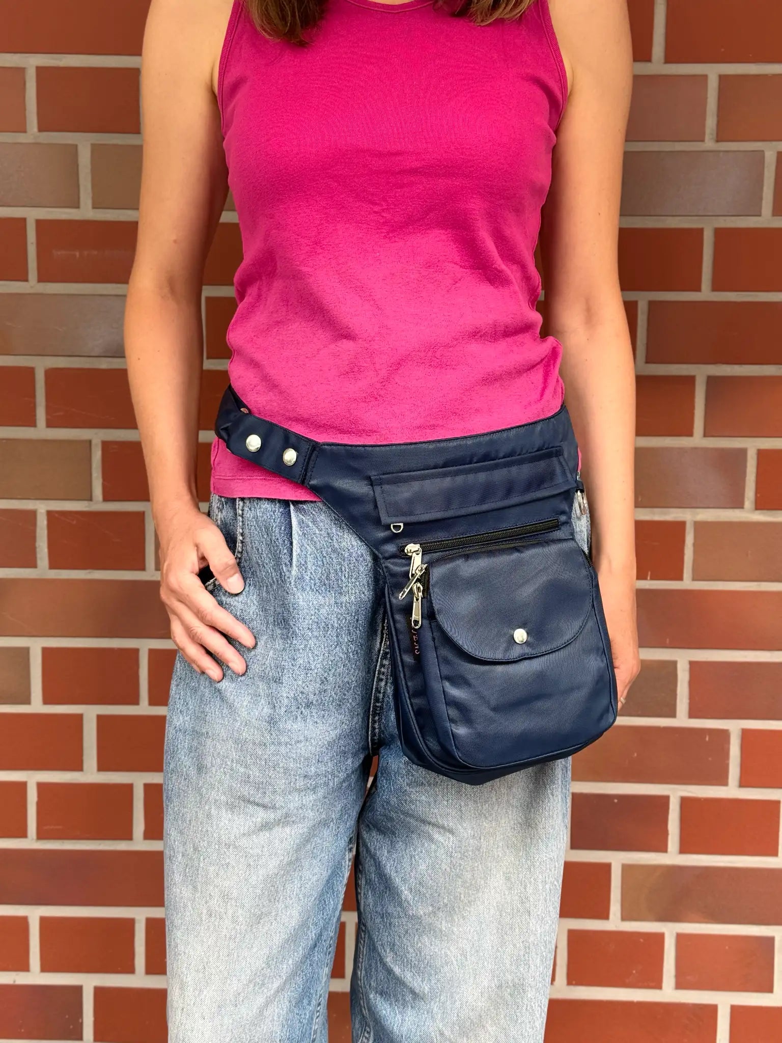 Dunkelblaue wasserabweisende NIJENS Super-Hannover Gassi-Tasche als Hüfttasche getragen. Funktionale Tasche mit mehreren Fächern für Hundezubehör und persönliche Gegenstände.