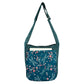 Nijens Big Shopper in Petrol mit floralen Libellen-Motiven, zeigt das geräumige Außenfach mit einem Buch darin.