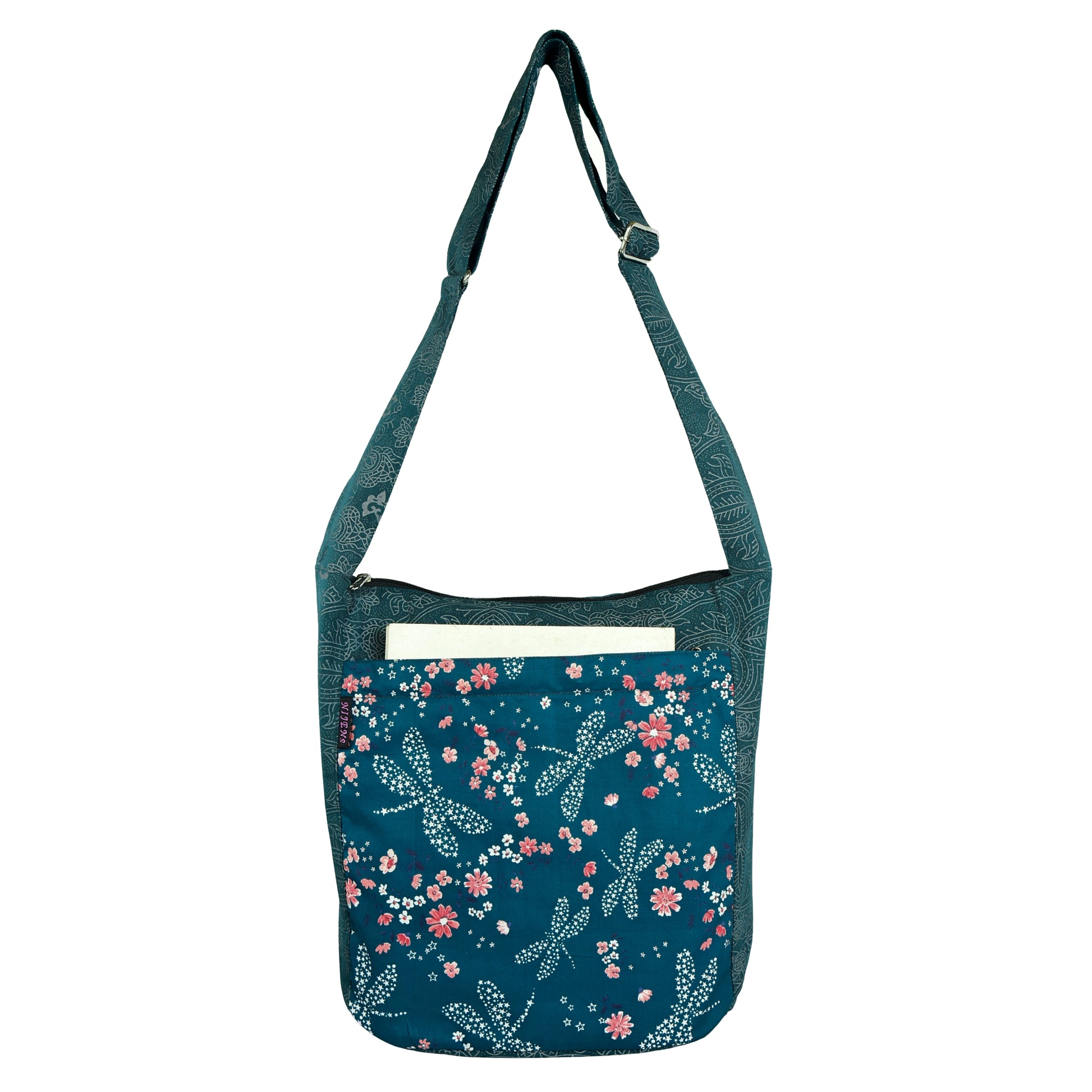 Nijens Big Shopper in Petrol mit floralen Libellen-Motiven, zeigt das geräumige Außenfach mit einem Buch darin.