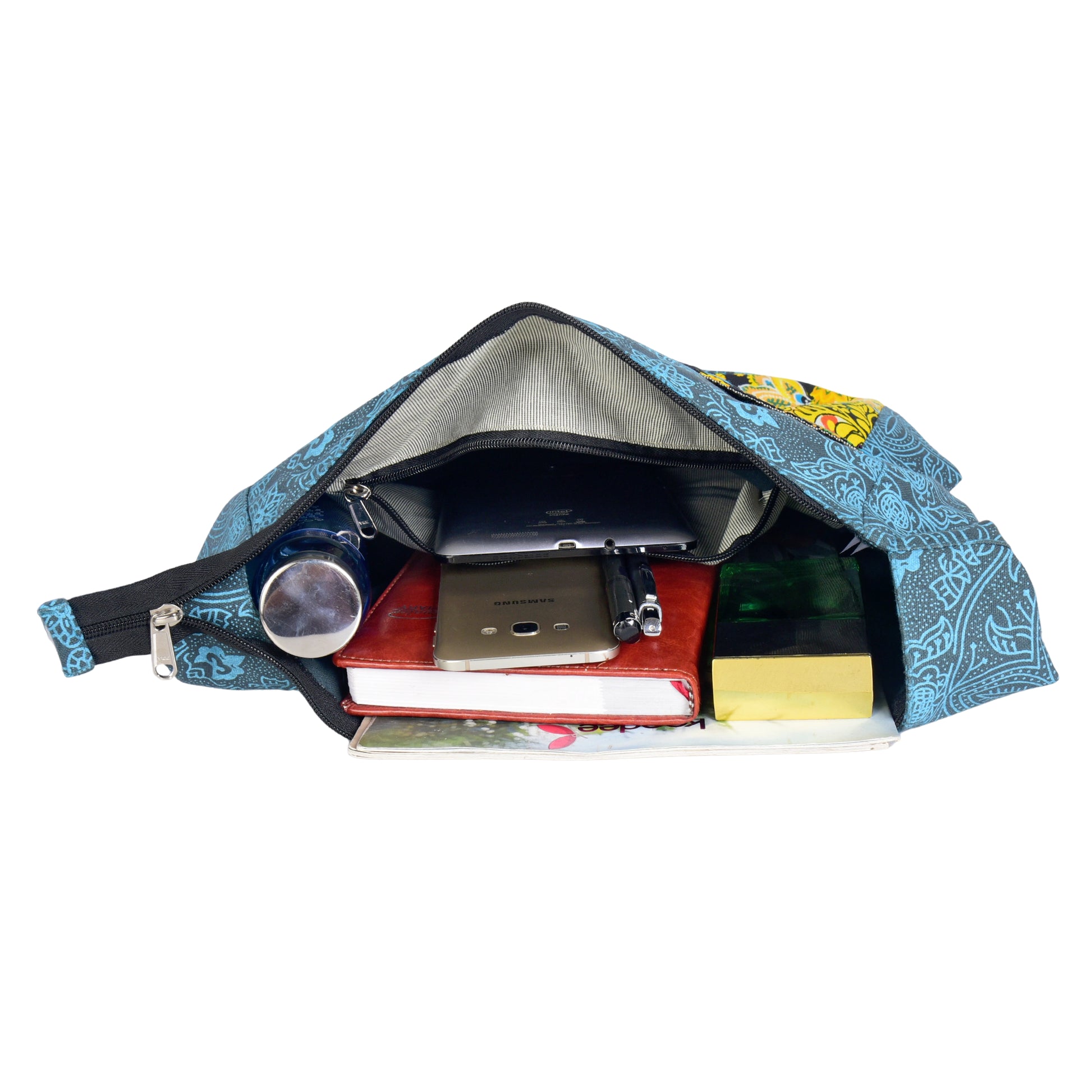 Geöffneter blauer Big Shopper mit Mandala-Design, gefüllt mit Büchern, Handy, Flasche und Notizbuch – zeigt das große Hauptfach.