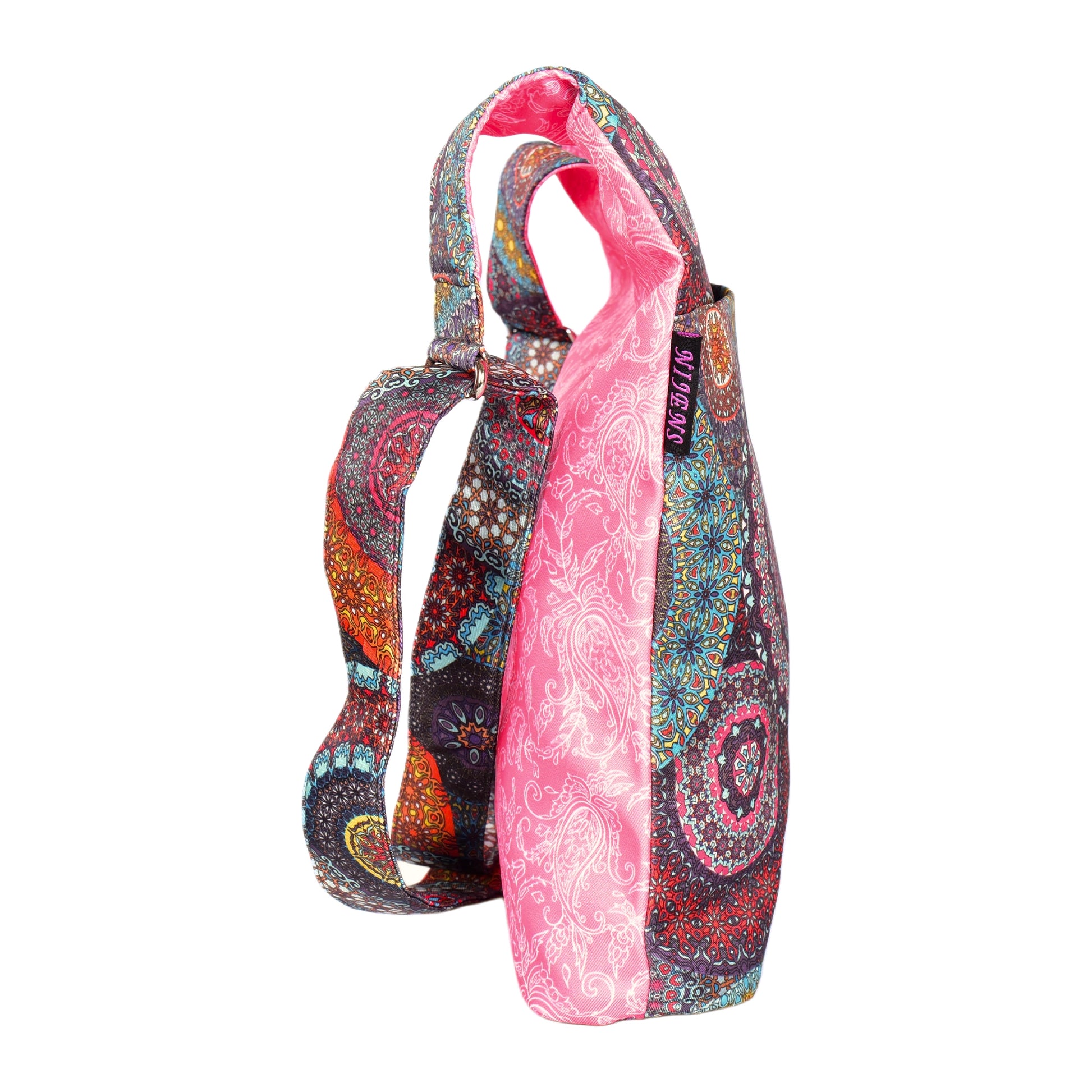 Seitliche Ansicht: Shopper von Nijens – Wende-Umhängetasche mit floralen Muster in Rosa und gemustertem Riemen, wasserabweisend.