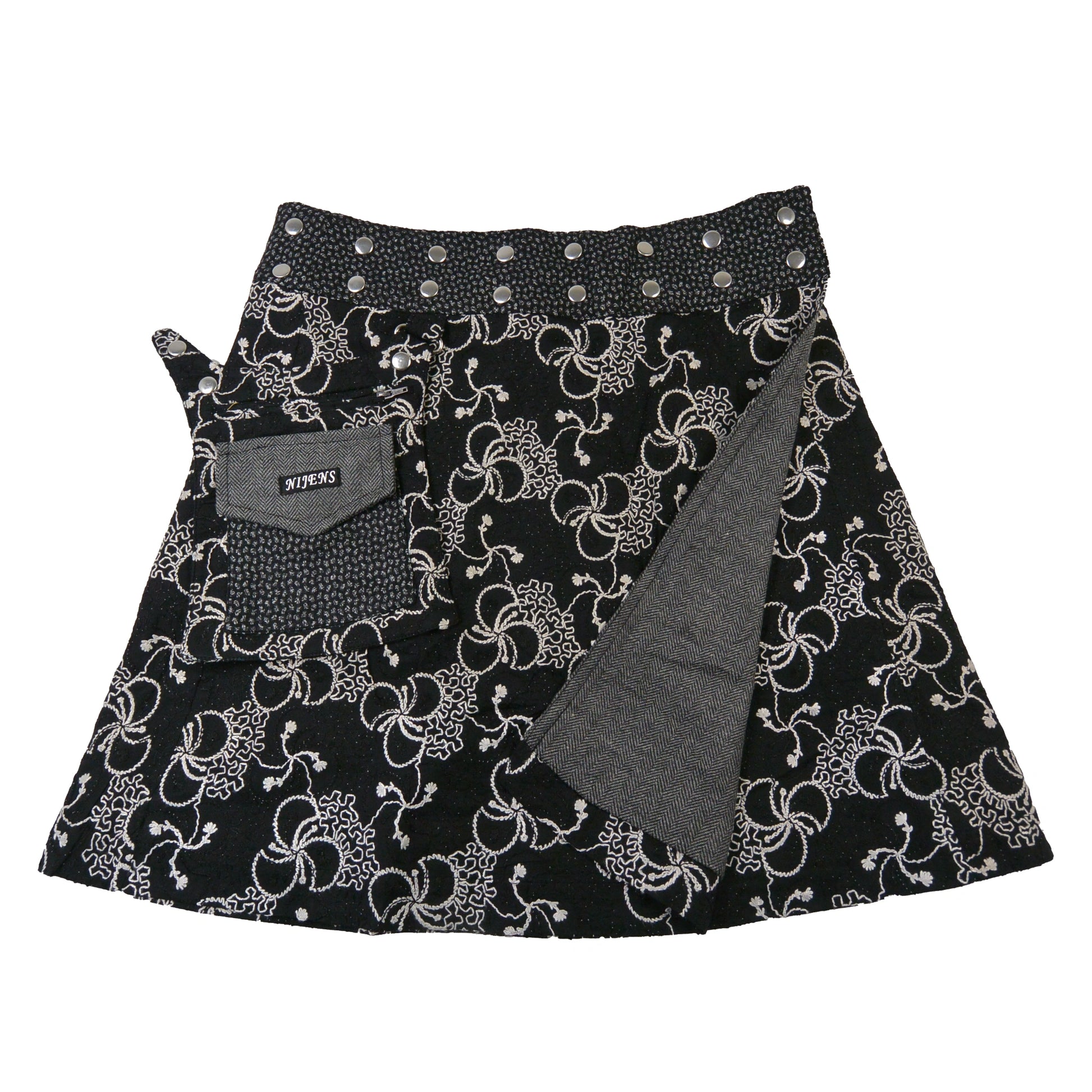 Rückseite des Tweed-Rocks in Grau mit Blumenmuster. 