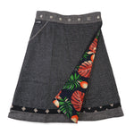 Frontseite des Wenderocks aus Tweed mit grauem Muster und farbenfroher Innenseite mit Blättern und Früchten