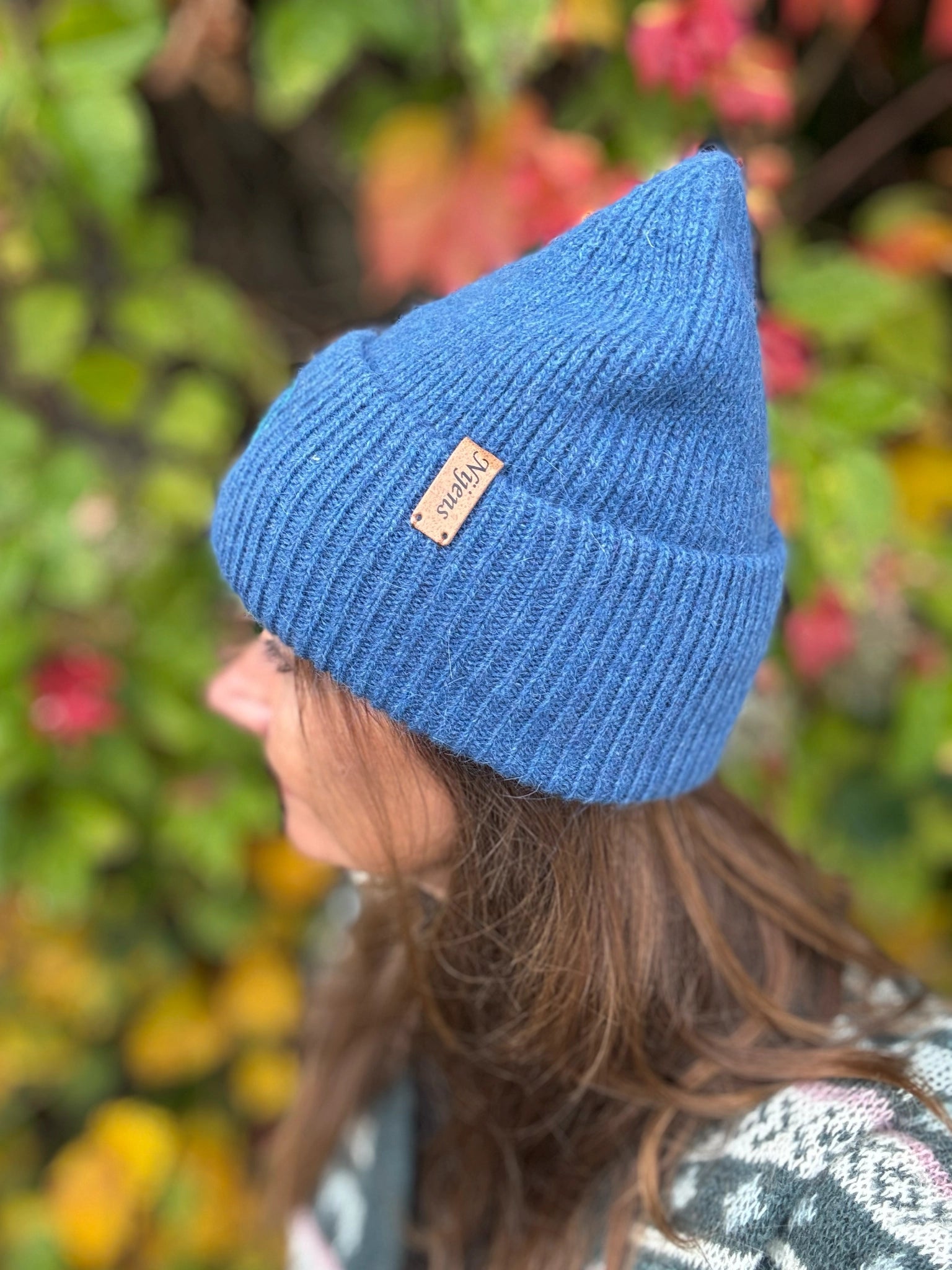 Frau trägt blaue Nijens Angora Beanie beim herbstlichen Spaziergang